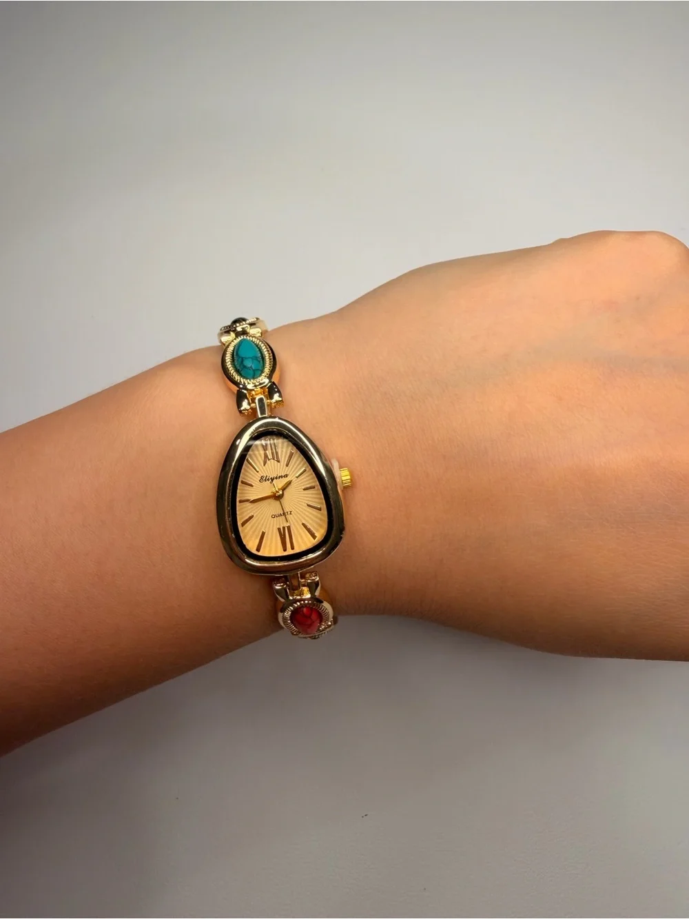 Gold Teardrop Dial Bracelet Watch with Red, Black and Turquoise Accents